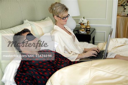 Mature couple relaxing in bed