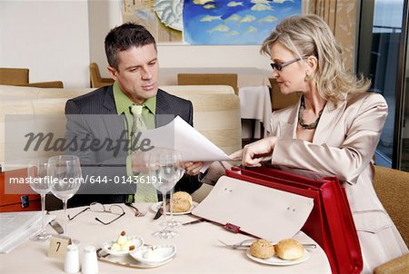 Businessman and businesswoman meeting in a restaurant