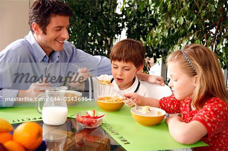 Father and children eating breakfast