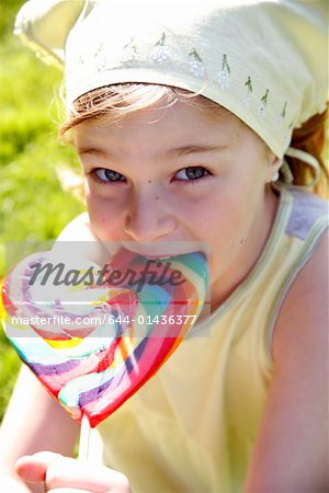 Young girl lick Cute little girl licking lollipop — Stock Photo © gabczi ...