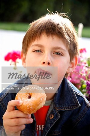 Young boy eating a doughnut