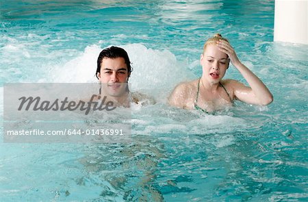 Young couple swimming in spa pool