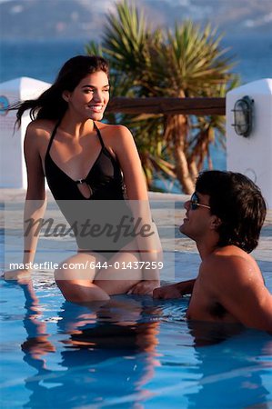 Couple at seaside swimming pool