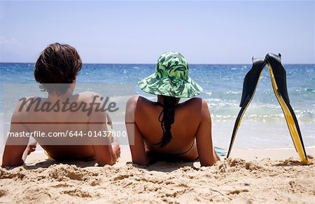 A couple with flippers on the beach