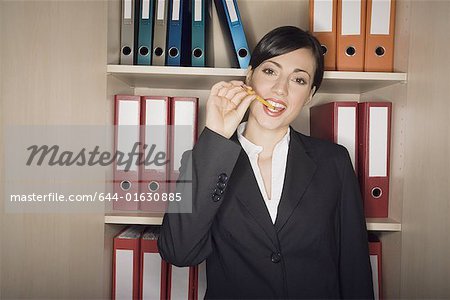 Office worker with pencil in her mouth