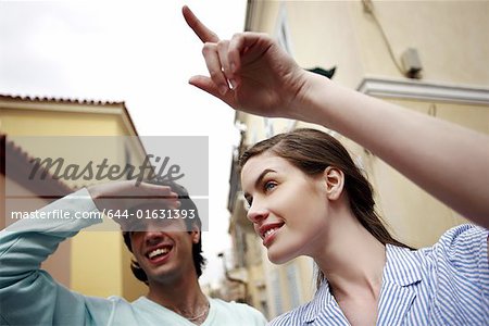 Woman pointing to show man the way