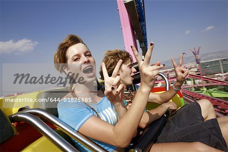 Teenage couple on amusement park ride