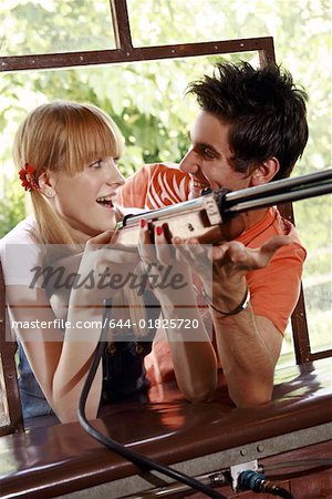 Teenage couple at shooting game in amusement park