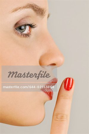 Female young adult;finger to lips