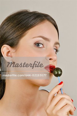 Female young adult eating a lollipop