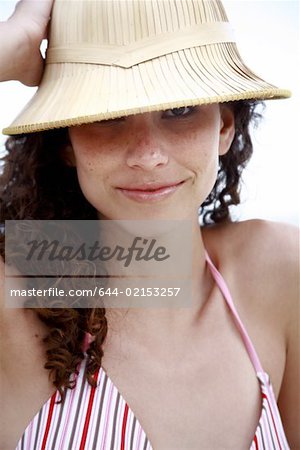 Female young adult wearing sun hat on the beach