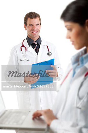 Doctor with laptop computer and doctor with medical chart