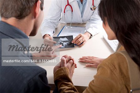 Doctor with ultrasound and couple