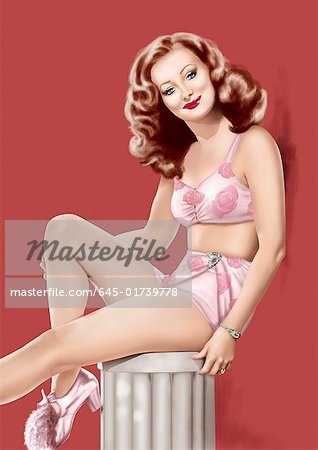 Pinup girl in pink flowery lingerie posing on column