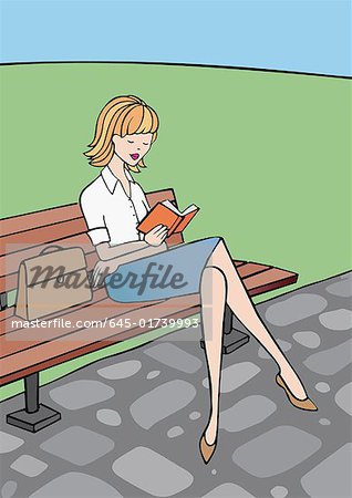 Woman sitting on park bench reading a book