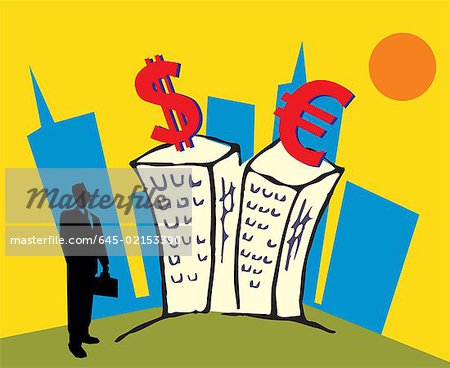Businessman standing by buildings and looking at currency symbols