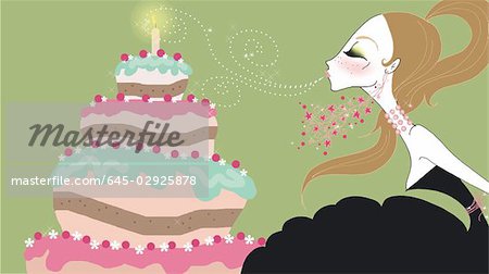 Young woman blowing out birthday candle