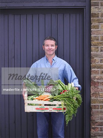 Man with a crate of vegetables