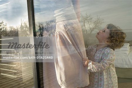 Mother and daughter (0-2) at window.