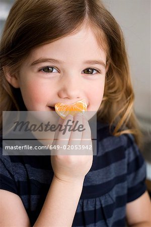 Girl holding tangerine