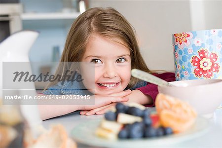 Girl smiling behind some health food