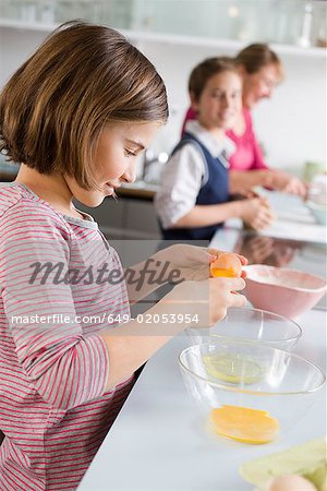 Girl separating egg yolk and egg white
