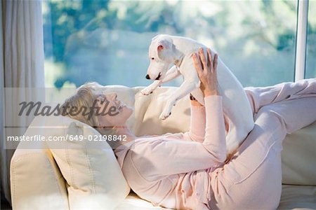 Woman Relaxing, Playing With Dog