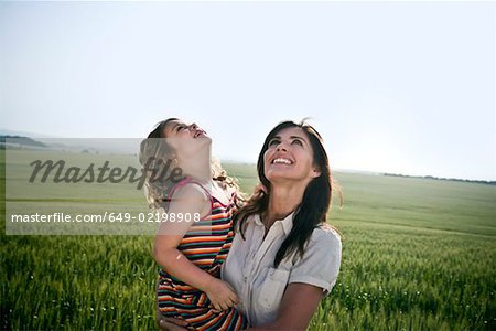 Woman and child looking at sky