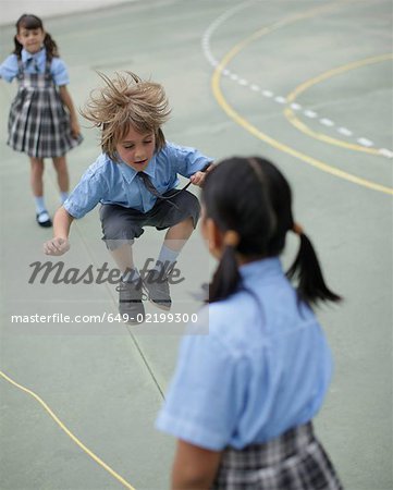 School boy skipping rope