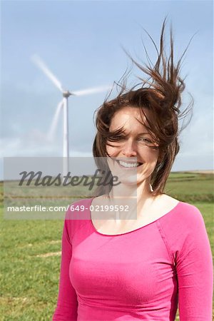 Woman with hair blowing on a wind farm