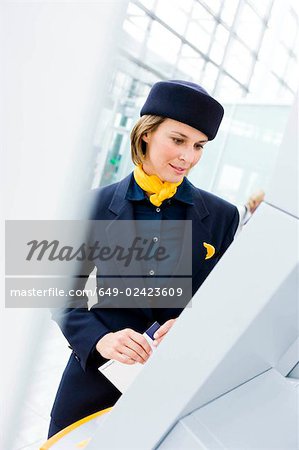 Stewardess looking at display