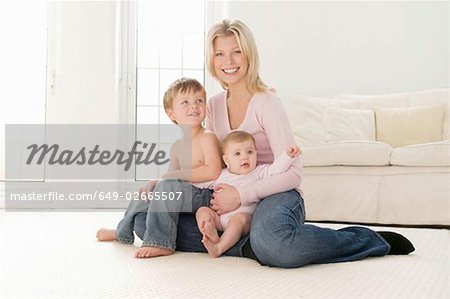 A mother sitting with her two children