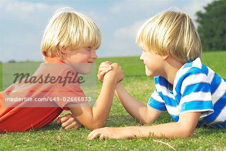 two boys arm wrestling