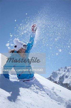 Woman jumping in snow