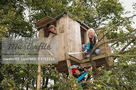 Children playing in treehouse