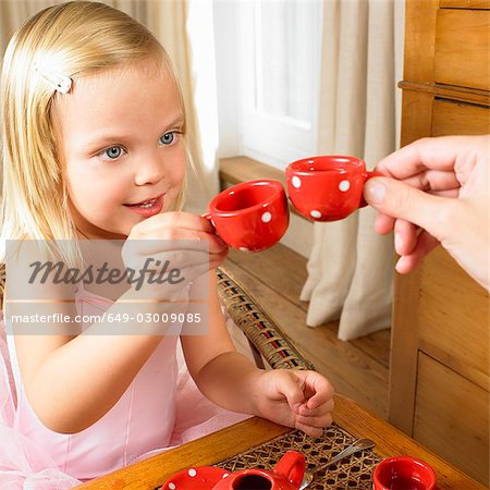 Girl having a tea time with her mother