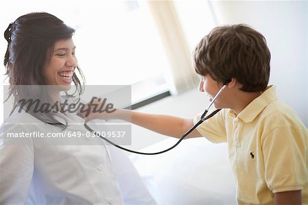 Boy Listening To Female Doctors Heart Stock Photo Masterfile Premium Royalty Free Code 649