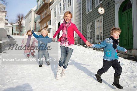 Scandinavian children running in snow