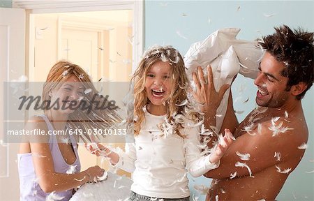 family having pillow fight