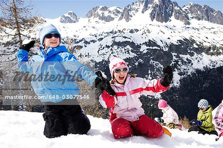 Two kids throwing snow.