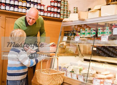 cheese store owner with boy in shop