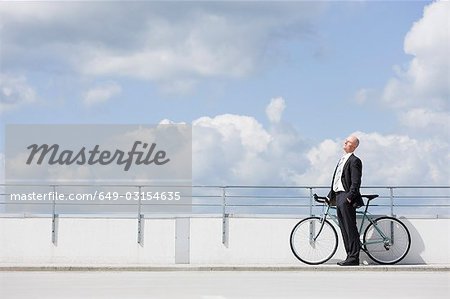 man with bycicle on car park