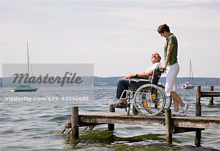 woman and senior man in wheelchair