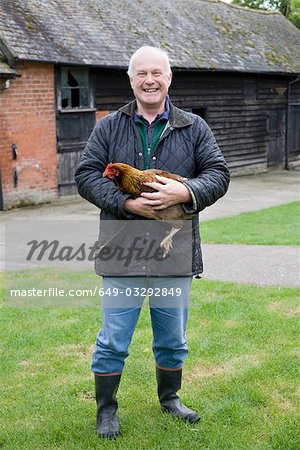 Farmer holding chicken