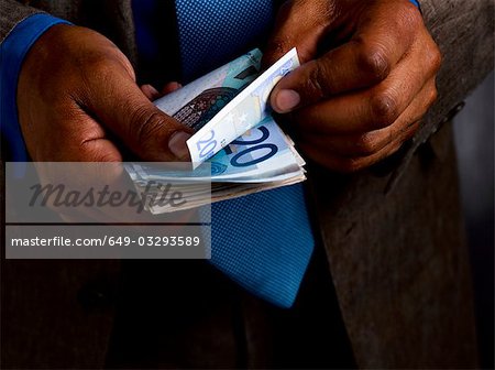 Business man counting euro bills