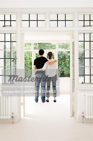 A young couple looking out of the window