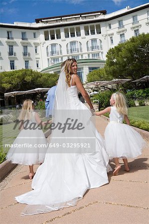 bride and children walk down path