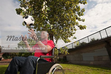 man in wheelchair with ball