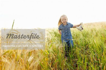 Girl running in a wheat field