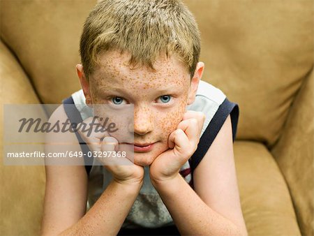 A young boy looking straight to camera